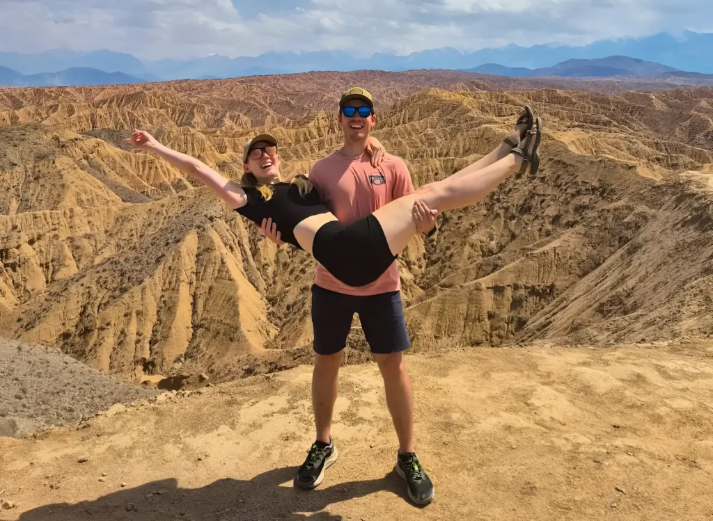 Our tourists enjoying the panoramic view in Ak-Sai Canyon, Kyrgyzstan, surrounded by stunning mountain landscapes.
